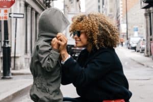 Mom smiling at son as she connects with her kid