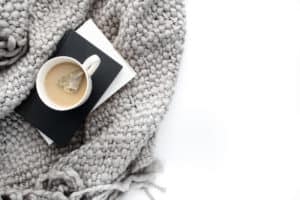 Cozy blanket with warm cup of tea