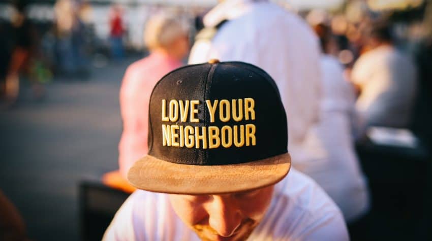 man wearing hat that says love your neighbor