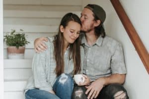 Husband kissing wife on head