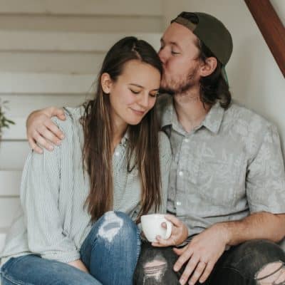 Husband kissing wife on head