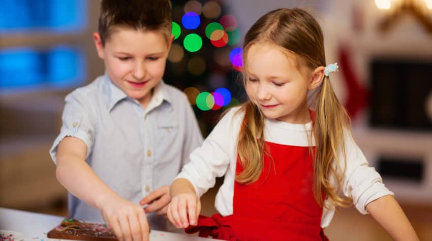 boy and girl decorating cookies as a Christmas tradition