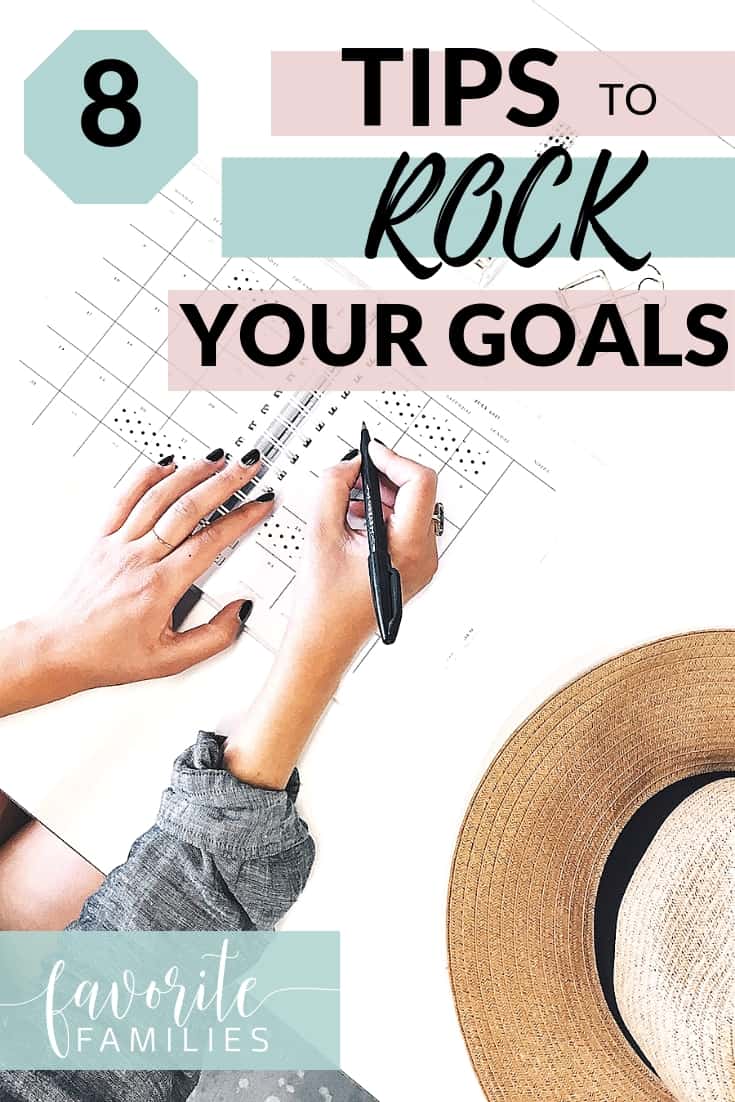 Woman writing in planner with text overlay 8 Tips to Rock Your Goals