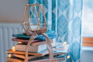 beautiful stack of books decorated with lights