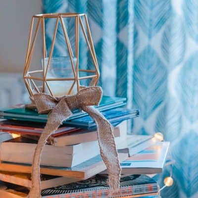 beautiful stack of books decorated with lights