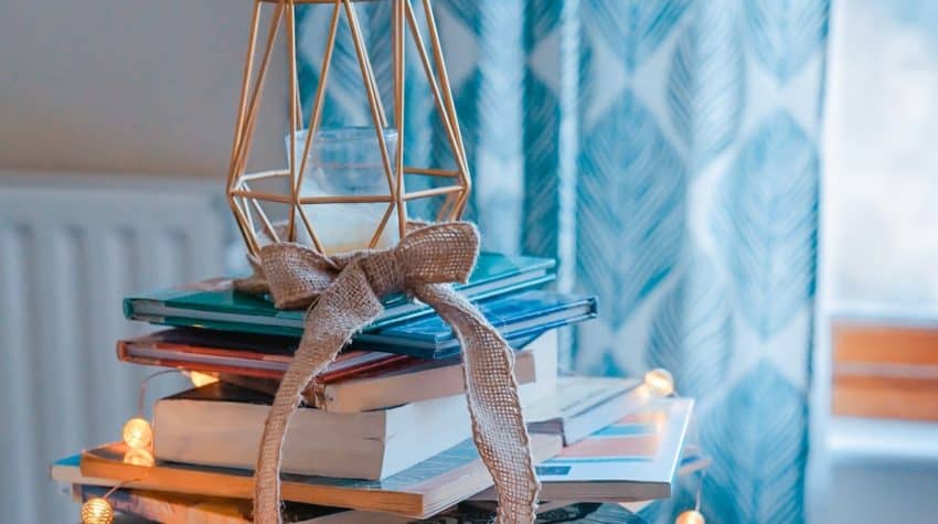 beautiful stack of books decorated with lights