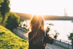 woman going through rough times staring over water