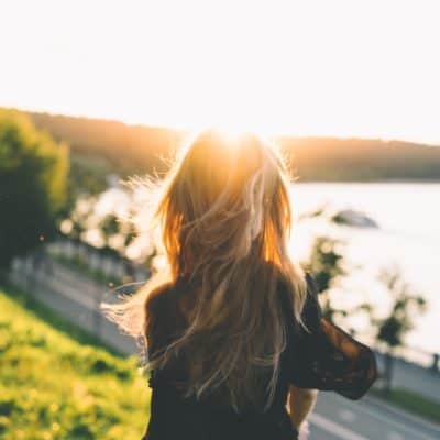 woman going through rough times staring over water