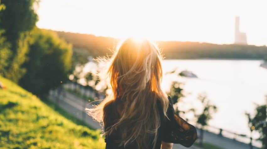 woman going through rough times staring over water