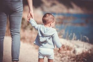 Mom using positive discipline holding sons hand