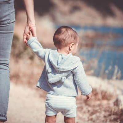 Mom using positive discipline holding sons hand