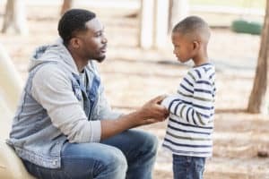 Dad using positive discipline with his son