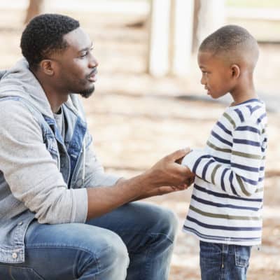 Dad using positive discipline with his son