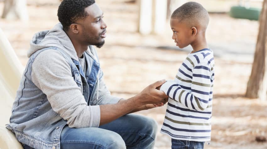 Dad using positive discipline with his son