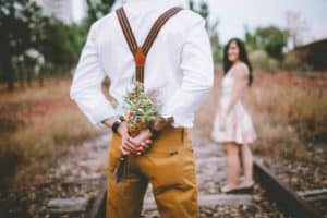 man holding flowers for wife