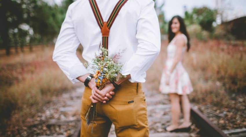 man holding flowers for wife