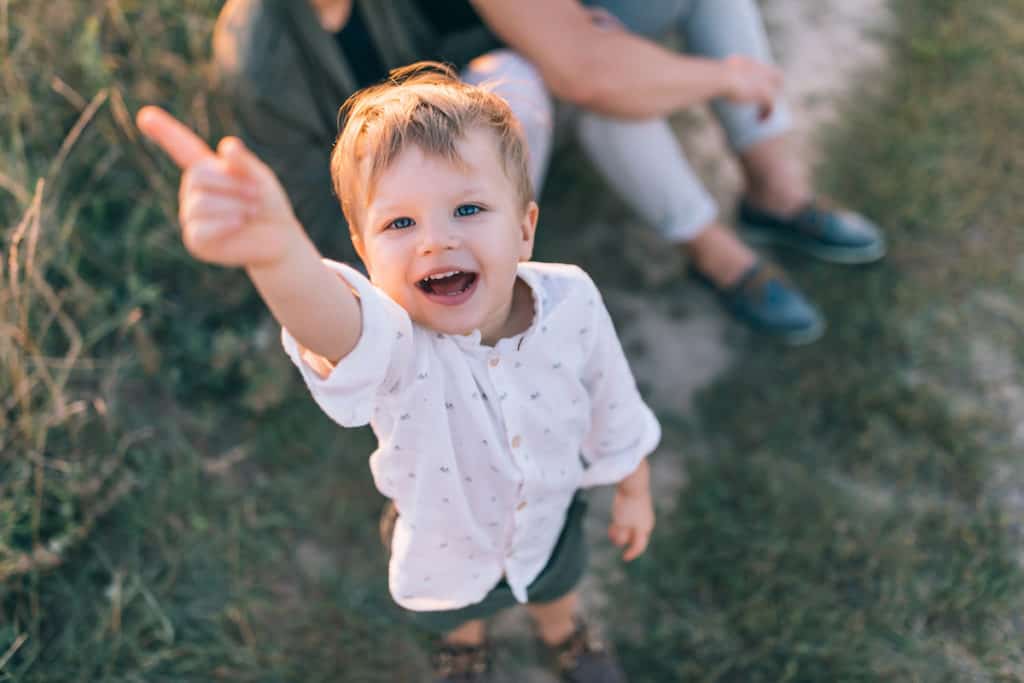 emotionally intelligent child smiling and pointing