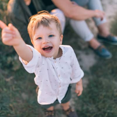 emotionally intelligent child smiling and pointing