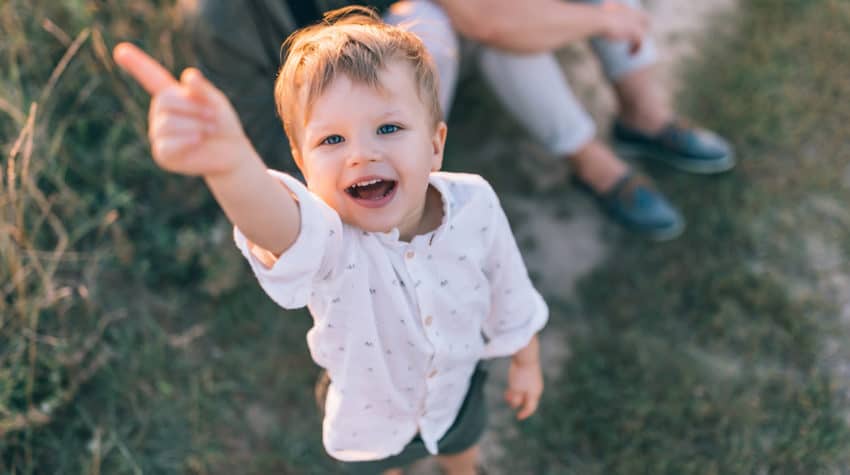 emotionally intelligent child smiling and pointing