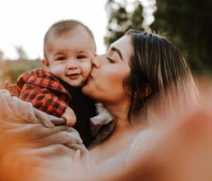 mom kissing baby