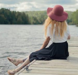 woman resting on dock by the water