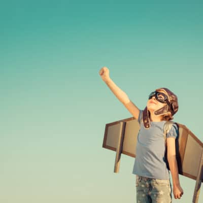 creative child wearing wings and goggles