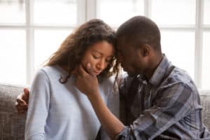 Couple comforting each other after miscarriage