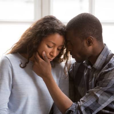 Couple comforting each other after miscarriage