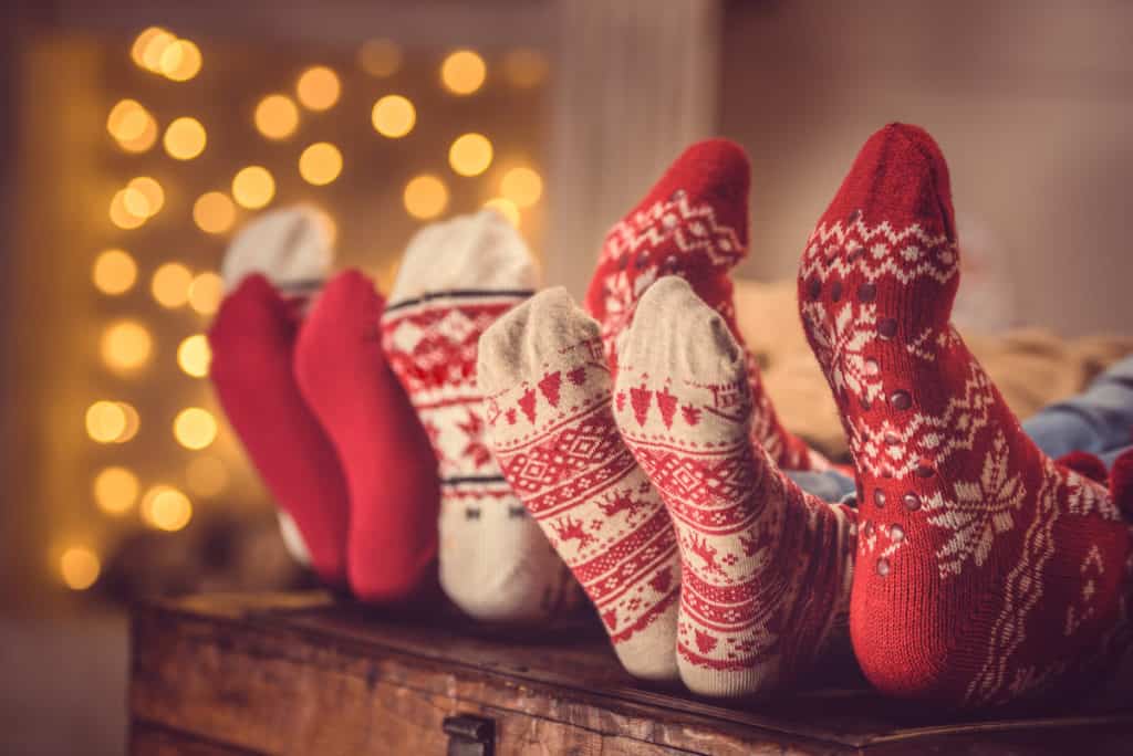 family relaxing and enjoying Christmas with feet up