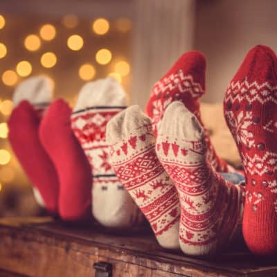 family relaxing and enjoying Christmas with feet up