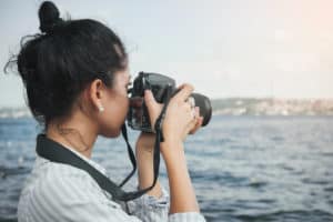 mom taking photos of ocean