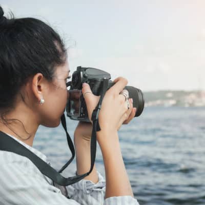 mom taking photos of ocean