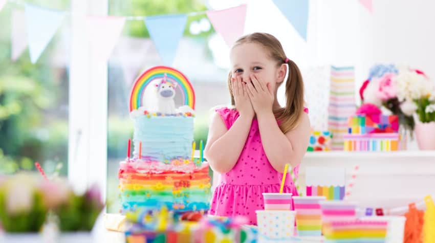 young girl excited about birthday cake