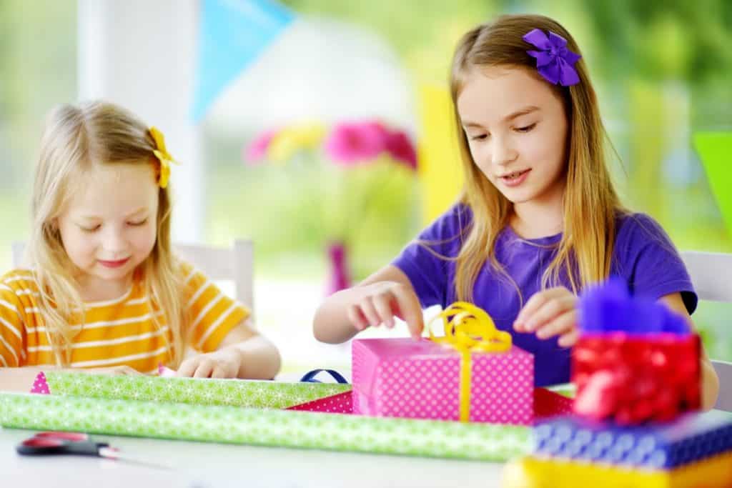 two cute sisters wrapping presents