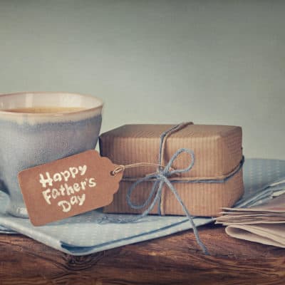 Father's Day gift on wooden table with cup of coffee