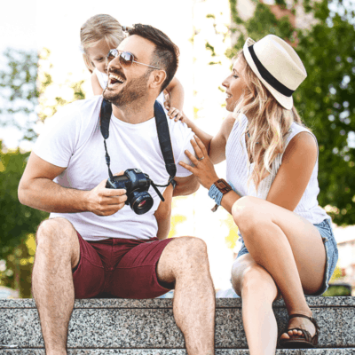 smiling family of 3 on vacation